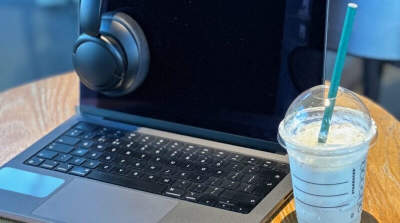 a laptop computer sitting on top of a wooden table